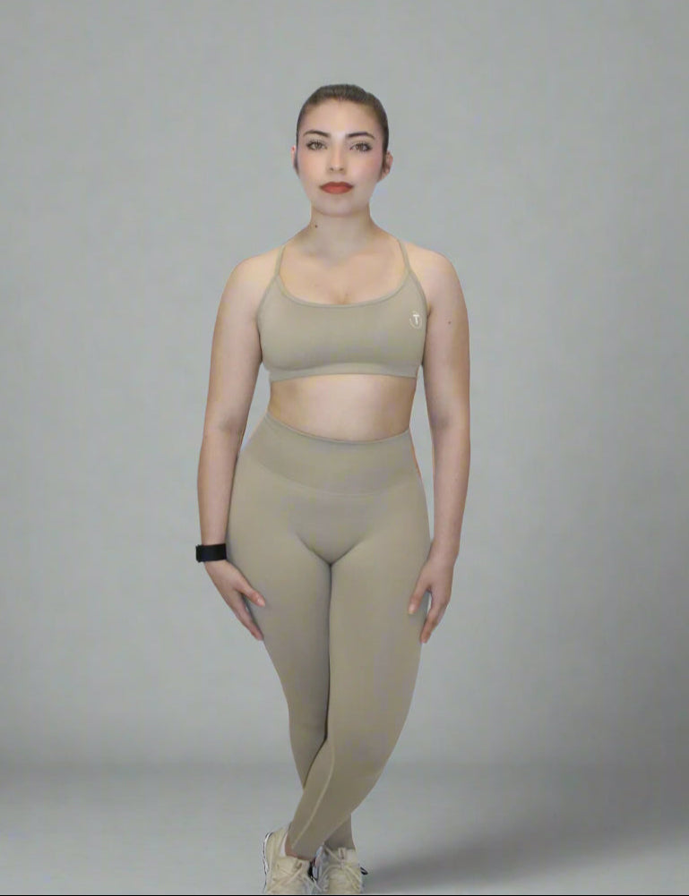 Woman wearing beige sports bra and legging
