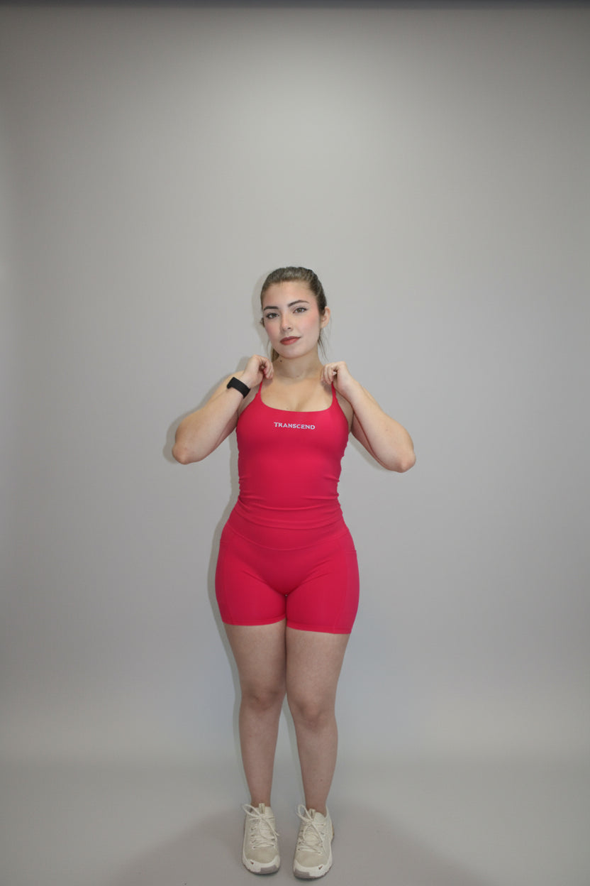 Person wearing a pink outfit standing on a white backdrop