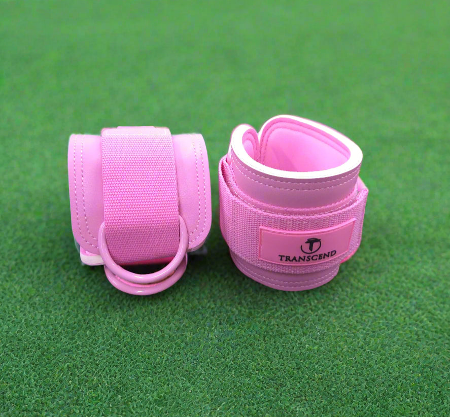 Pink ankle straps with a Transcend brand logo on a gray turf
