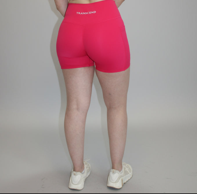Person wearing a pink outfit on a white background at a studio