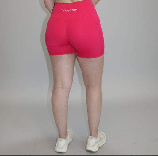 Person wearing a pink outfit on a white background at a studio